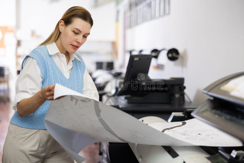 Worker in a Printing and Press Centar Check Print Quality Stock Image