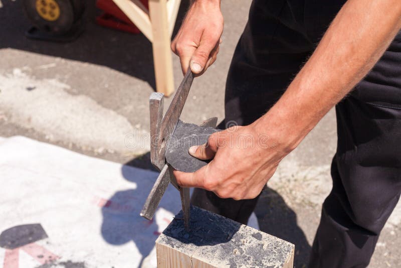 Worker produces roofing slate using a slate hammer. 
