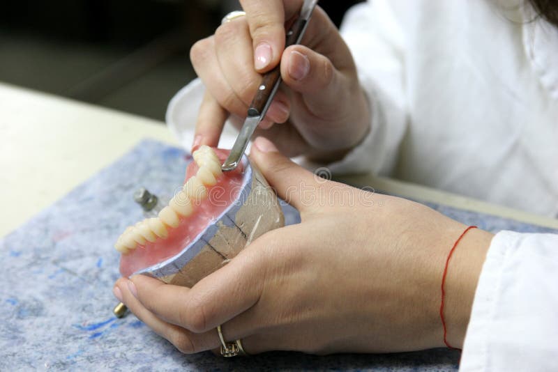 Worker producing fake teeth