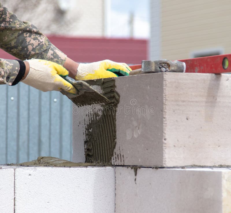Worker Puts Foam Concrete Bricks into the Wall Stock Photo Image of cement, working 185126946