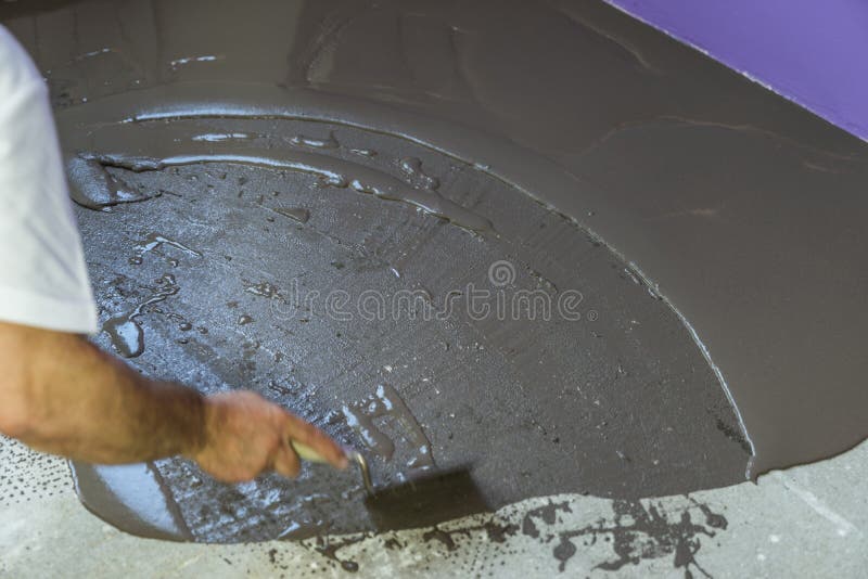 Worker Puts a Self Leveling Screed with Trowel on Concrete Floor Stock Photo Image of
