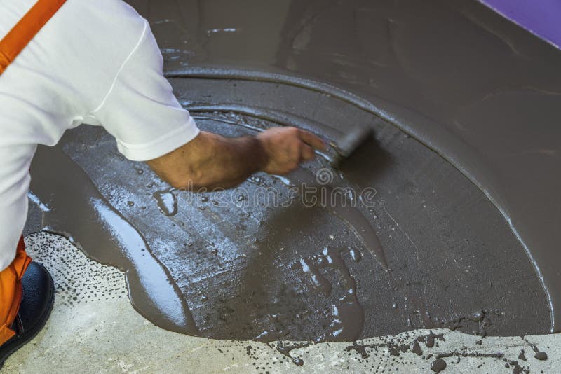 Worker Puts a Self Leveling Screed with Trowel on Concrete Floor Stock Photo Image of cement