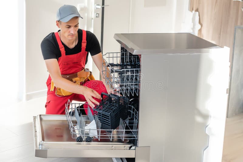 Worker Repair Dishwasher at Home. Stock Photo Image of pipes