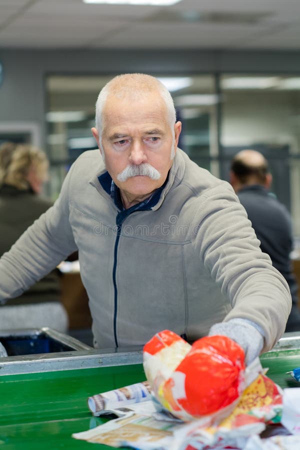 Worker or Reusable Plastic Factory Segregating Rubbish Stock Photo