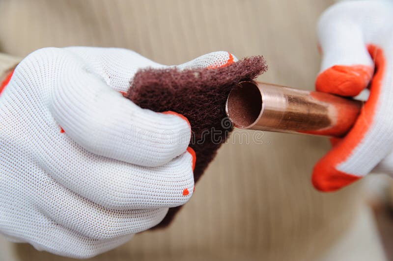 A Worker is Rubbing the Copper Tube. Stock Photo Image of pipelines