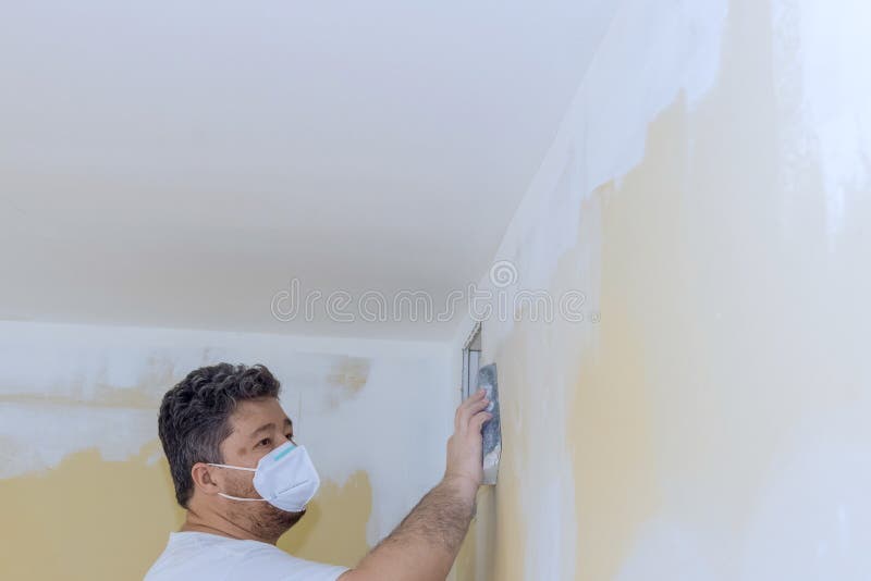 The Worker Sanded the Drywall Mud Using a Sand Trowel at the Time of