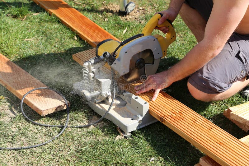 A Worker Saw Wood with a Chop Saw Stock Image Image of outside