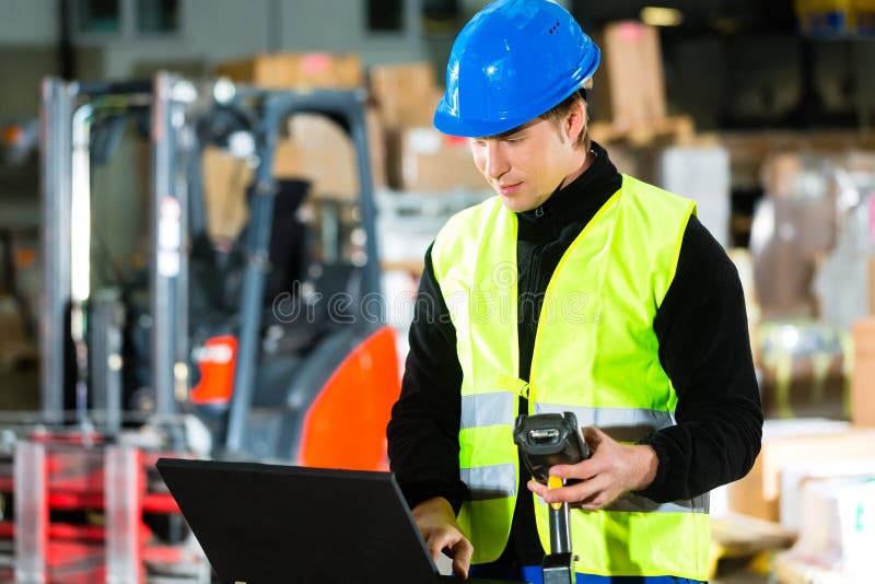 Worker with scanner and laptop at forwarding stock photos Worker with scanner and laptop at forwarding stock photos