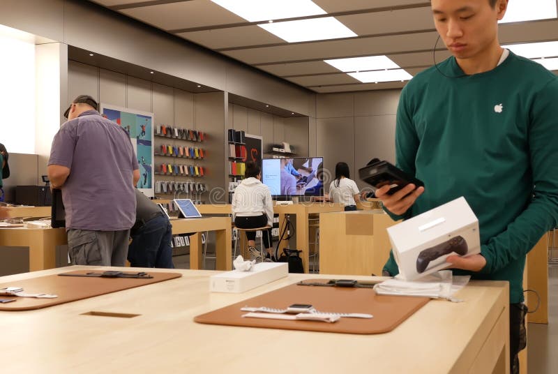 A Customer at an Apple Store Looking at His IPhone while Waiting at an Apple  Store Editorial Photo - Image of imac, computer: 237668441