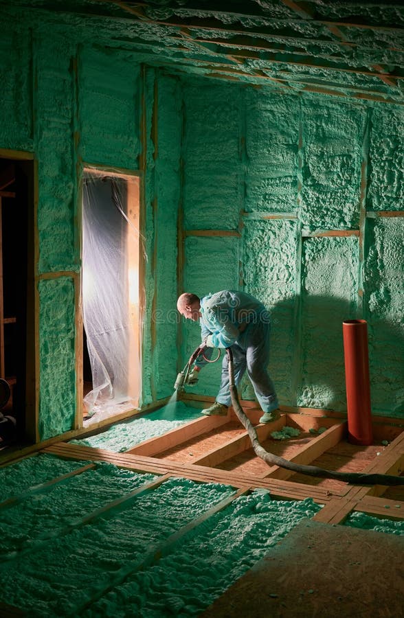 Worker Spraying Polyurethane Foam for Insulating Wooden Frame House