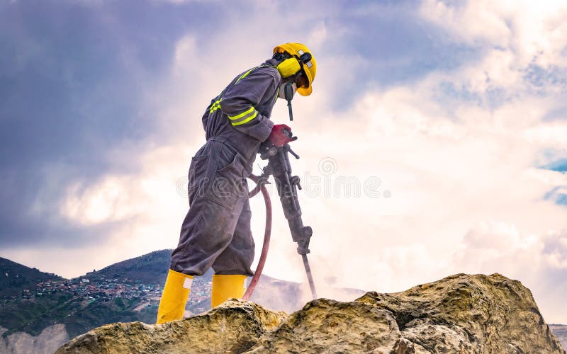 Worker on top of a rock stock photography Worker on top of a rock stock photography
