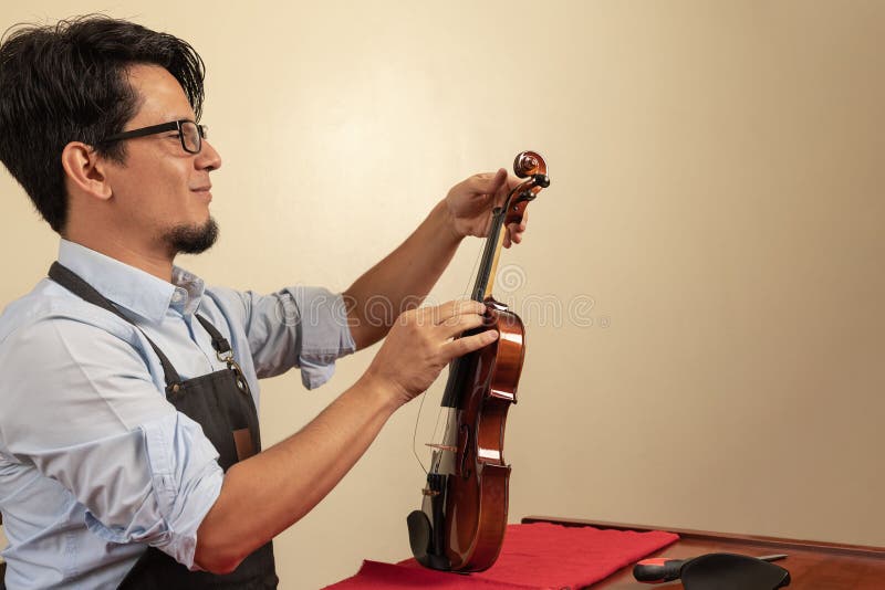 Worker Tuning a Violin in a Stock Image Image of composition