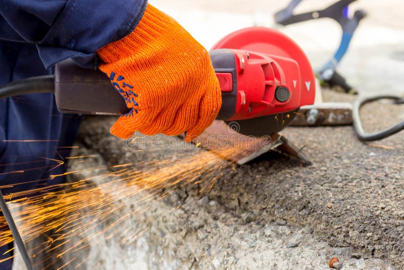 The Worker Uses an Angle Drive Grinder To Work with a Metal Corner