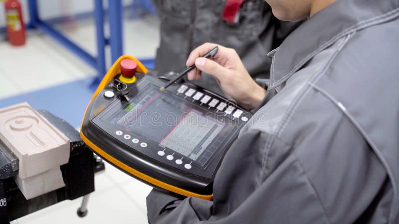 Worker Uses Touch Control Panel. Scene. Skilled Worker Uses Electronic