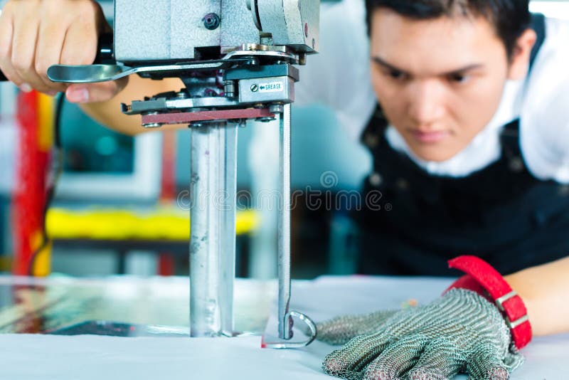 Worker using a machine in chinese factory stock photography Worker using a machine in chinese factory stock photography