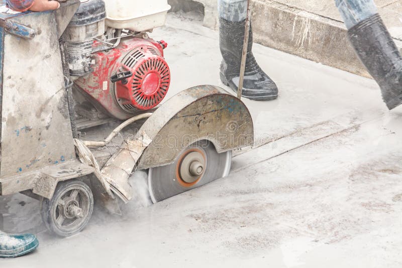 Worker Using Diamond Saw Blade Machine Cutting Concrete Road at Construction Site Stock Image