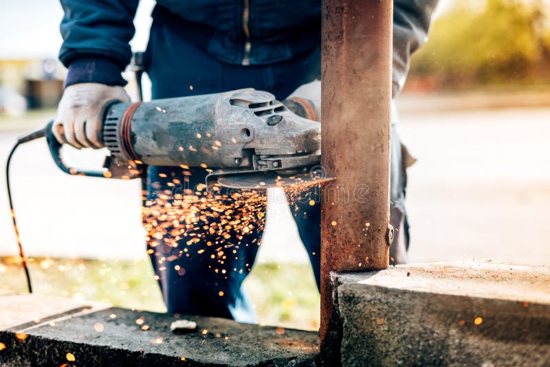 Worker Using Electric Angle Grinder Mitre Saw for Cutting Metal