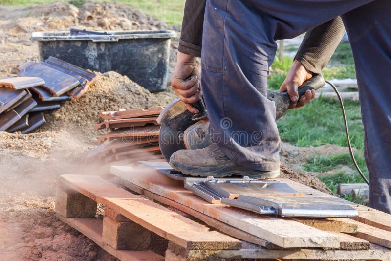 Worker Using a Hand Circular Saw To Cut Rooftile Stock Photo Image