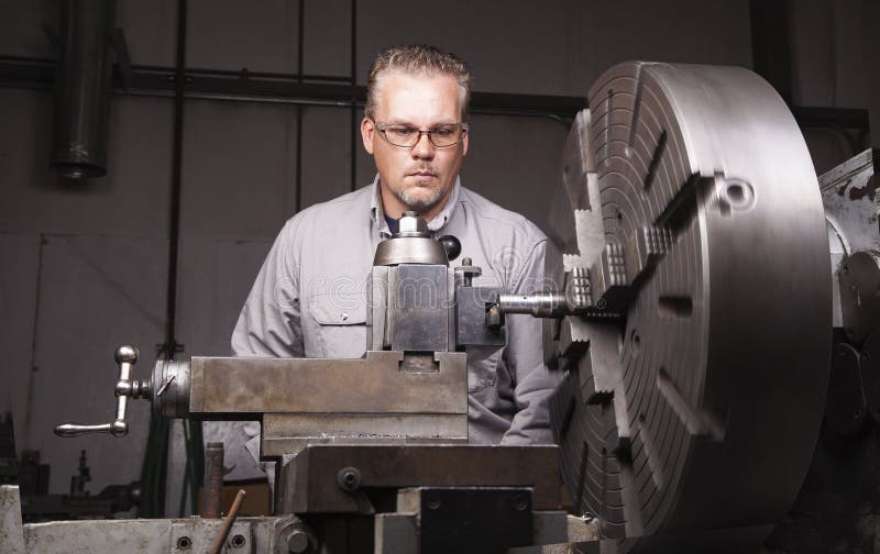 Worker using Metal Lathe stock photo. Image of industrial - 26377604