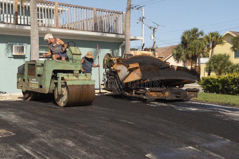 Worker Using a Road Roller on a New Driveway. Editorial Stock Photo