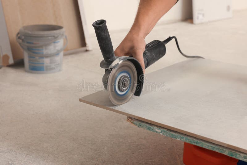 Worker Using Saw with Circular Diamond Blade for Tile Cutting Indoors, Closeup Stock Image