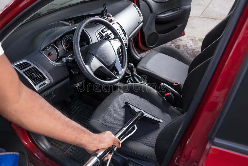 Worker Vacuuming Car Interior