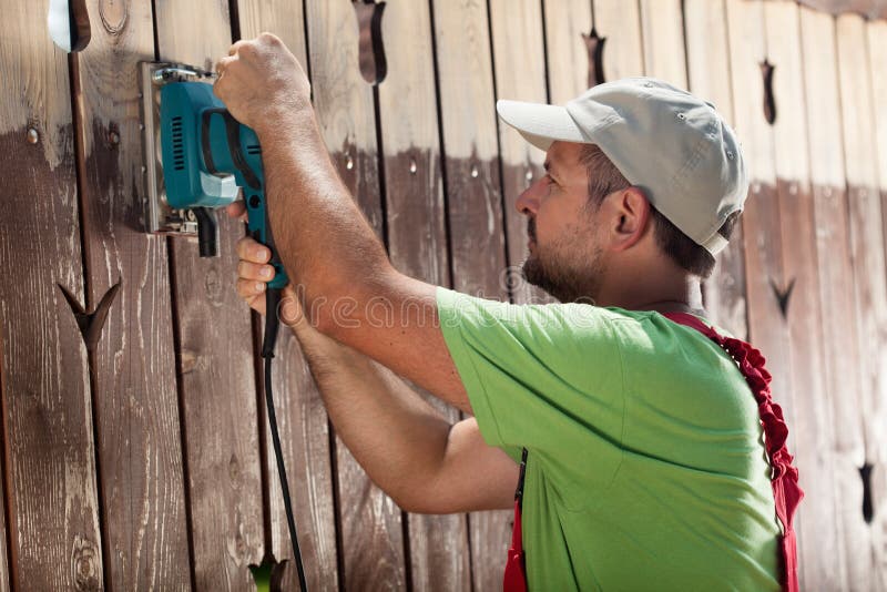 Worker with vibrating sander stock photos