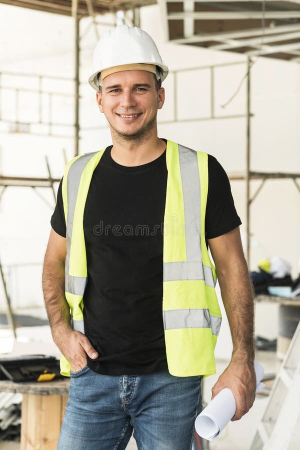 Worker Wearing Hard Hat Nad Safety Vest on a Construction Site Stock