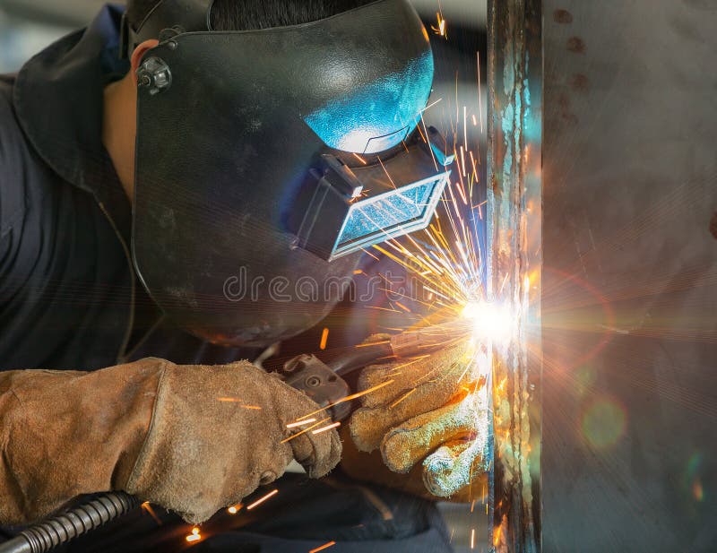 Worker welding construction by MIG welding