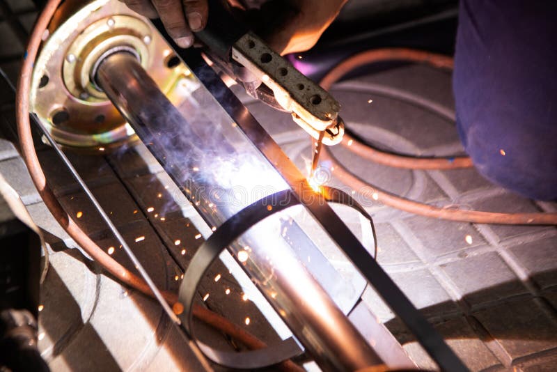 The Worker is Welding Metal Part of the Details of the System Rolling