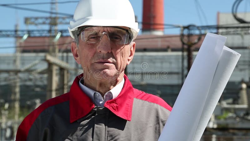 Worker in white hard hat at power station