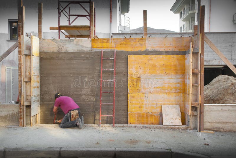 A Worker working in a construction site. Bricklayer tiler stock images, royalty-free photos and pictures