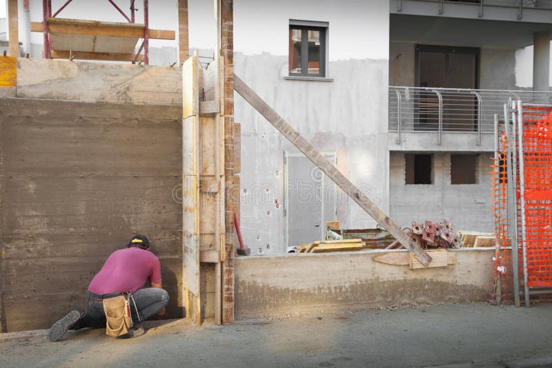 A Worker working in a construction site. Bricklayer tiler stock images, royalty-free photos and pictures
