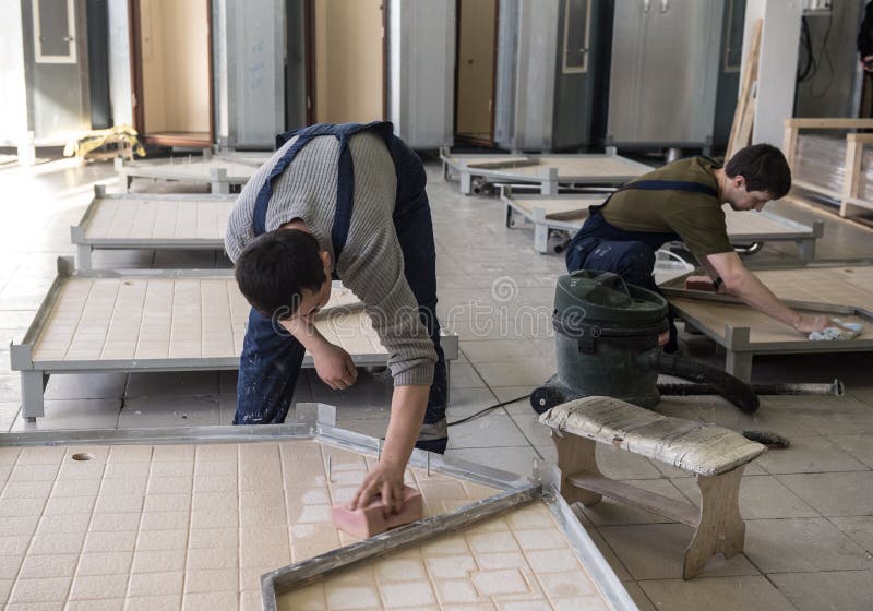 Workers assemble shower cabins ship stock images Workers assemble shower cabins ship stock images
