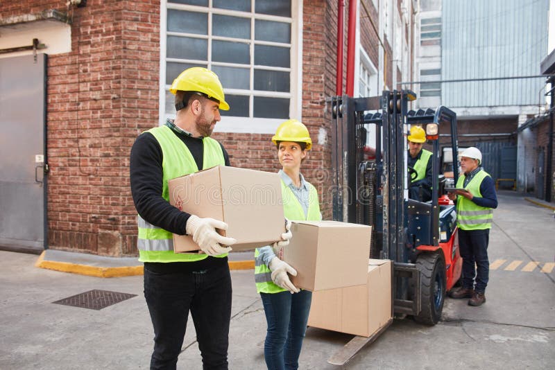Workers carry boxes for shipping stock photo