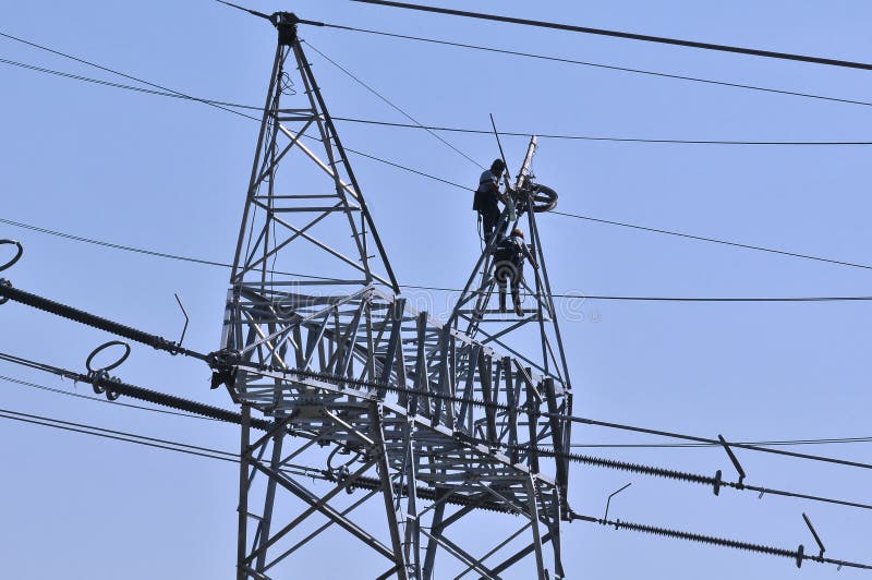 Workers on electricity poles
