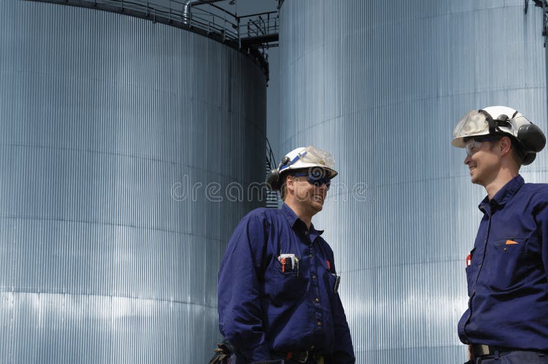 Workers and fuel storage tanks