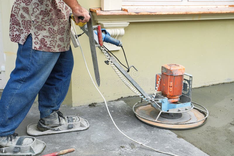 The Workers Grind the Concrete Floor at the Construction Site Stock