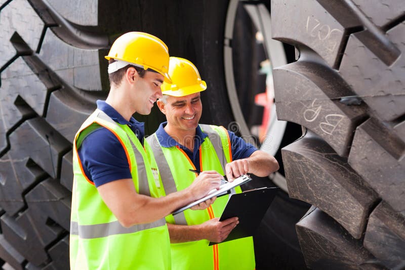 Workers inspecting tires