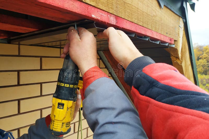 Workers Install Eaves Under the Roof of the House Stock Photo Image