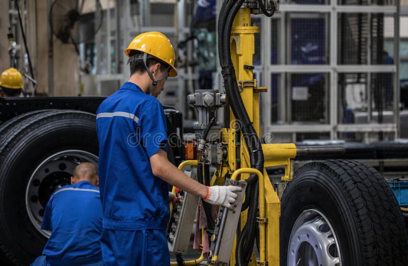 Workers in machinery factory in China. stock photo