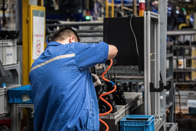 Workers in machinery factory in China. stock photos