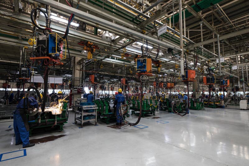 Workers in machinery factory in China. stock image
