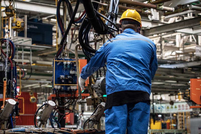 Workers in machinery factory in China. royalty free stock photography