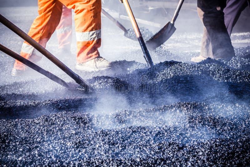 Workers making asphalt with shovels