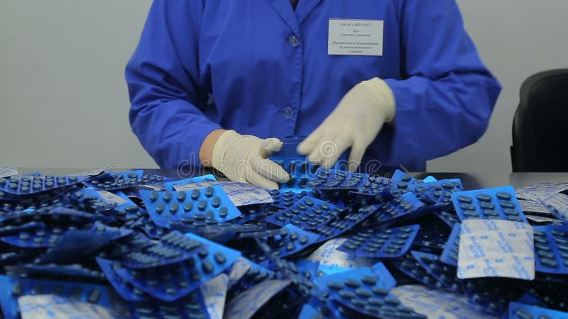 The workers of the pharmaceutical factory sort of blisters stock video
