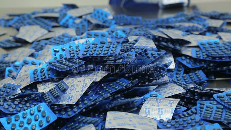 The workers of the pharmaceutical factory sort of blisters stock footage