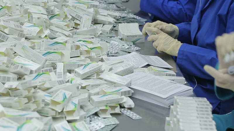 The workers of the pharmaceutical factory sort of blisters stock video