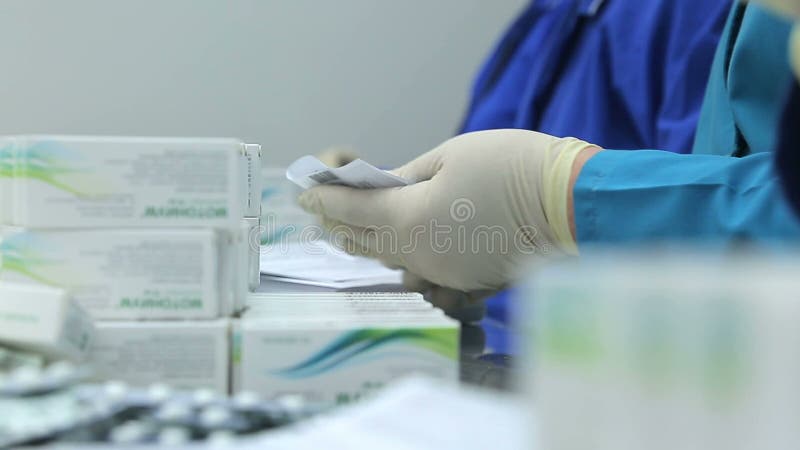 The workers of the pharmaceutical factory sort of blisters stock video