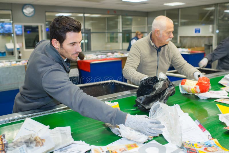Workers Removing Non Recyclable Things on Conveyor Belt Stock Photo